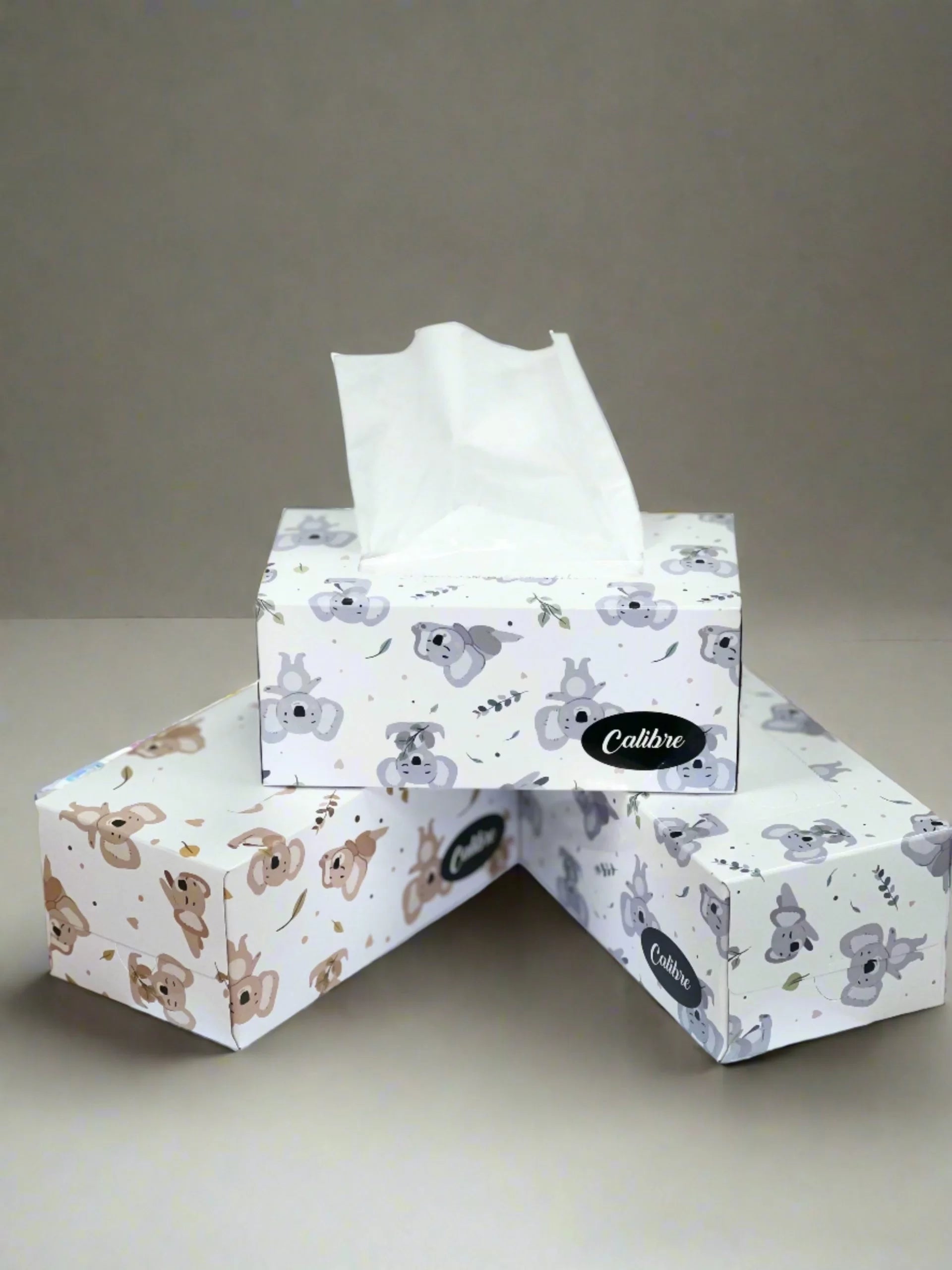 Three Calibre facial tissue boxes with cute koala and animal print design, stacked together