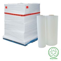 Stack of white plastic sheets on a pallet with two additional sheets beside them, featuring a recycling symbol.